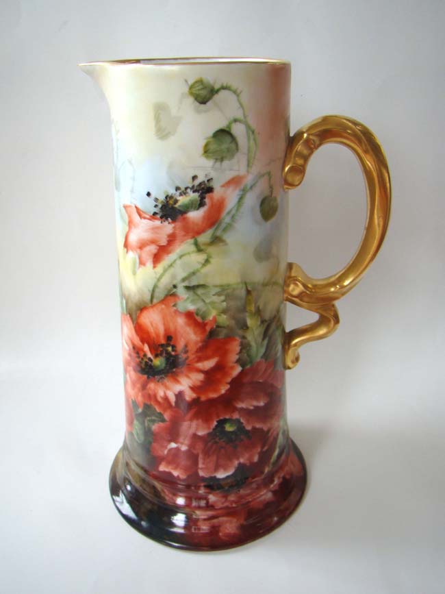 A tall and beautiful late 19th century hand painted German porcelain wine jug